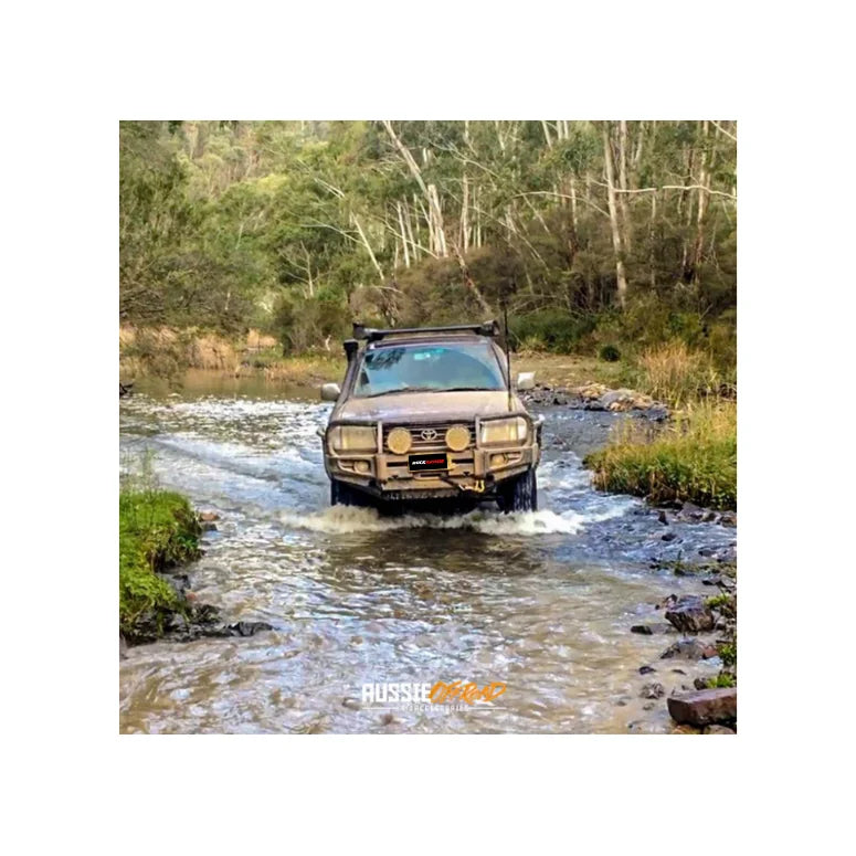 Brown toyota landcruiser fj105 fitted with rockarmor premium steel bullbar featuring led fog lights full bar replacement