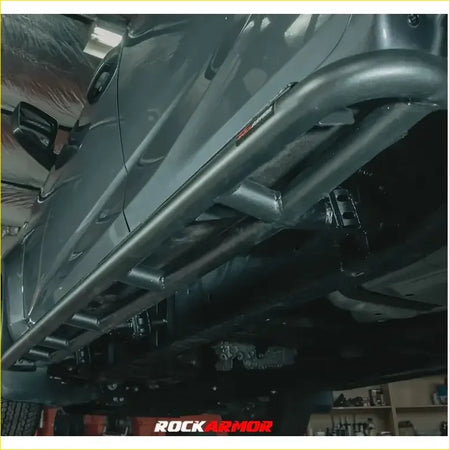 Black metal rock sliders with rugged tubular design and visible welds for landcruiser 100 series 98-07