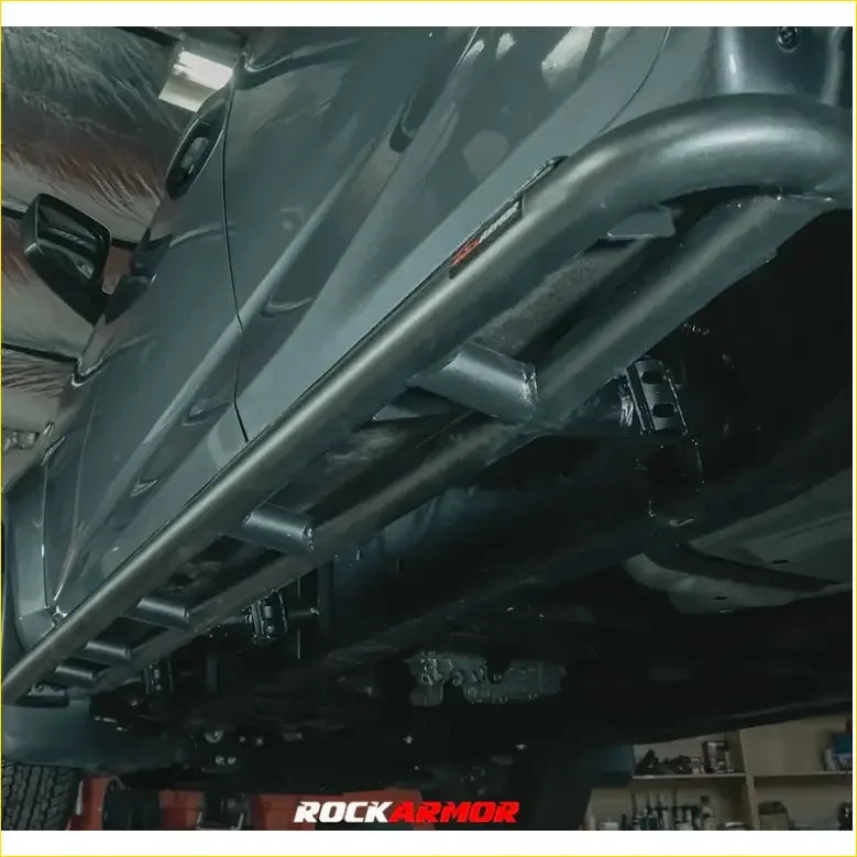 Black metal rock guard with rugged tubular design and visible welds for toyota landcruiser 200 gx gxl 07-2015